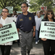 NAACP President Bruce Gordon and his wife Tawana Tibbs (L) participate in a march and rally for affirmative action on September 16, 2006, in Lansing, Michigan. The march was designed to oppose Proposal 2 on the Michigan ballot, which will be voted on November 7th.